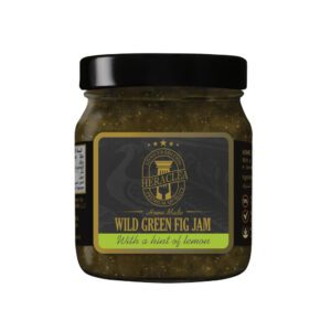 Jar of Heraclea Wild Green Fig Jam with a hint of lemon on a plain background.